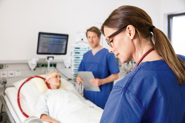 Patient on Getinge Cardiohelp System with 2 nurses