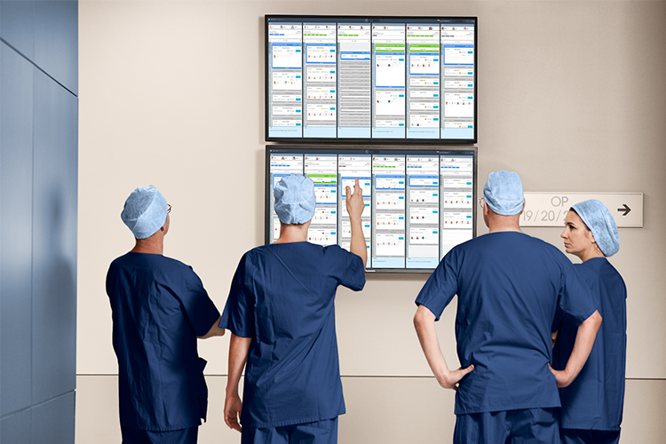 OR staff discussing or surgery plan on screen with Torin OR Management