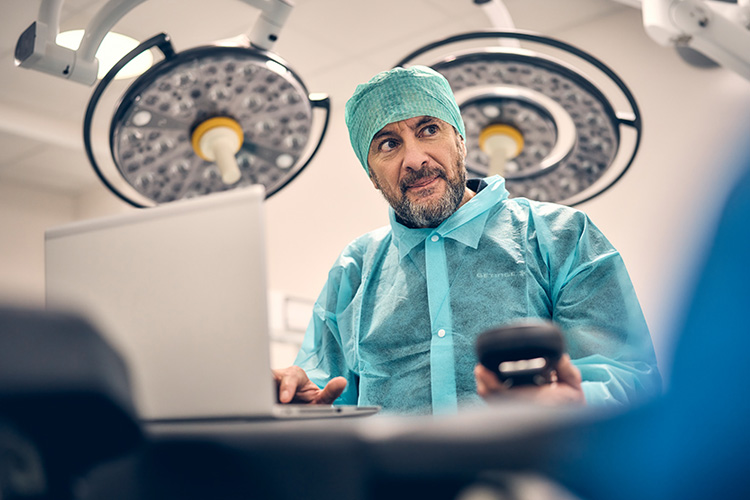 Service technician in clinical environment with a laptop Service technician in clinical environment with a laptop