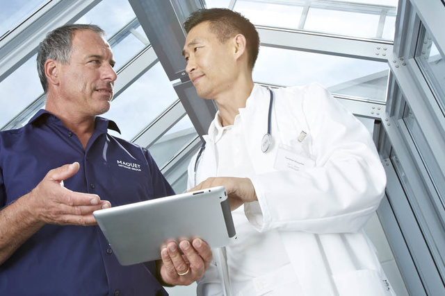 Doctor with a man holding ipad