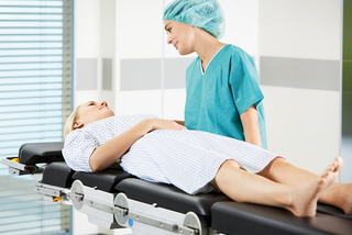 Nurse with patient on Maquet operating table