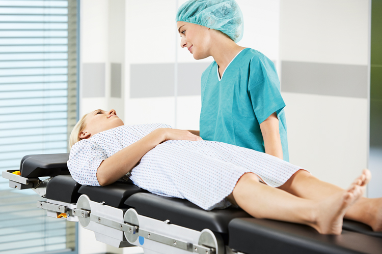 Nurse with patient on Maquet operating table