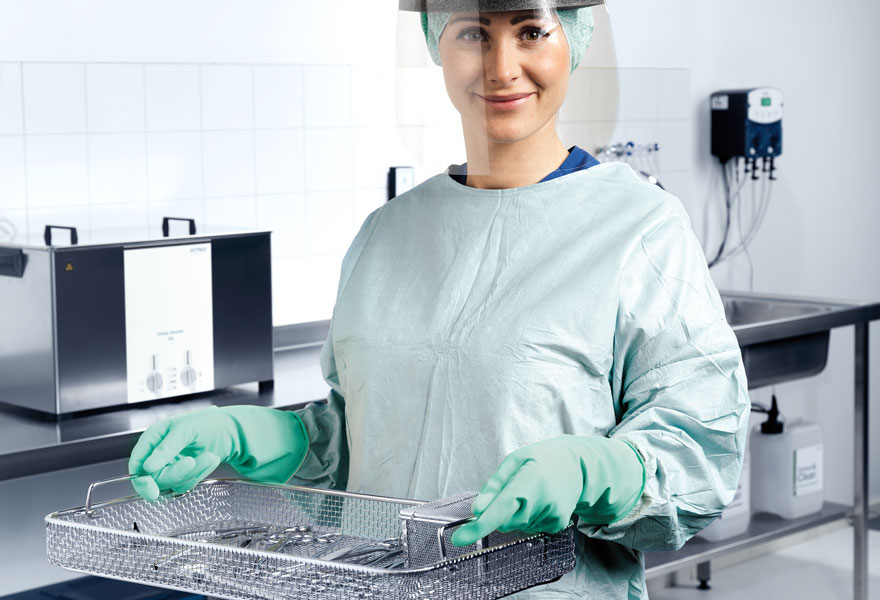 Nurse operating pre-cleaning sink dosing, Getinge Ultrasonic Cleaners