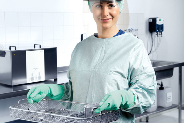 Nurse operating pre-cleaning sink dosing, Getinge Ultrasonic Cleaners