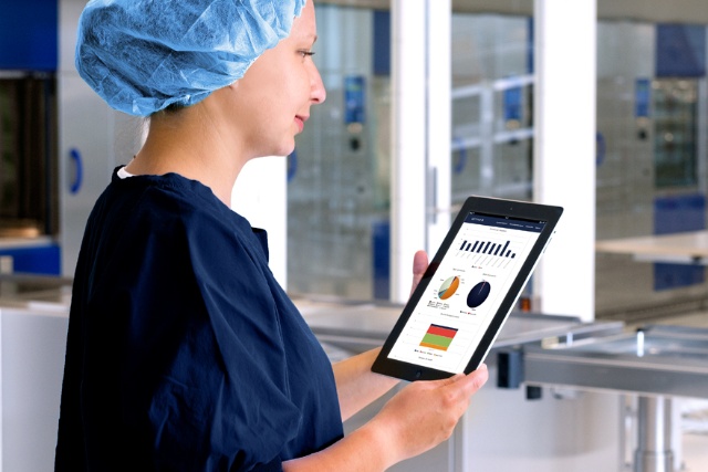 Female doctor looking at a tablet screen with graphics