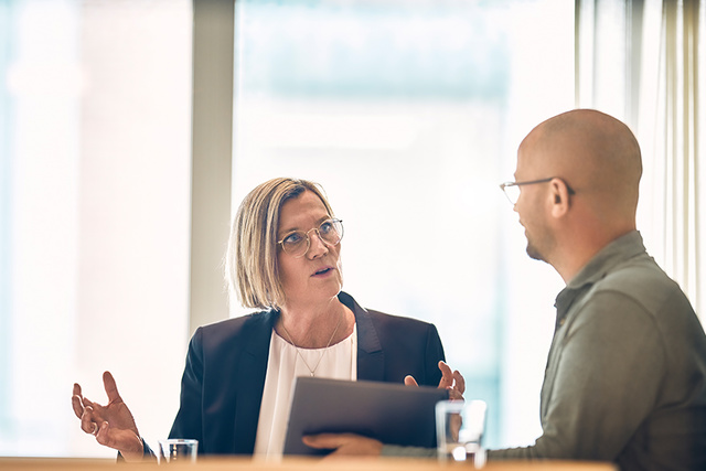 Man and woman in a discussion at a conference table