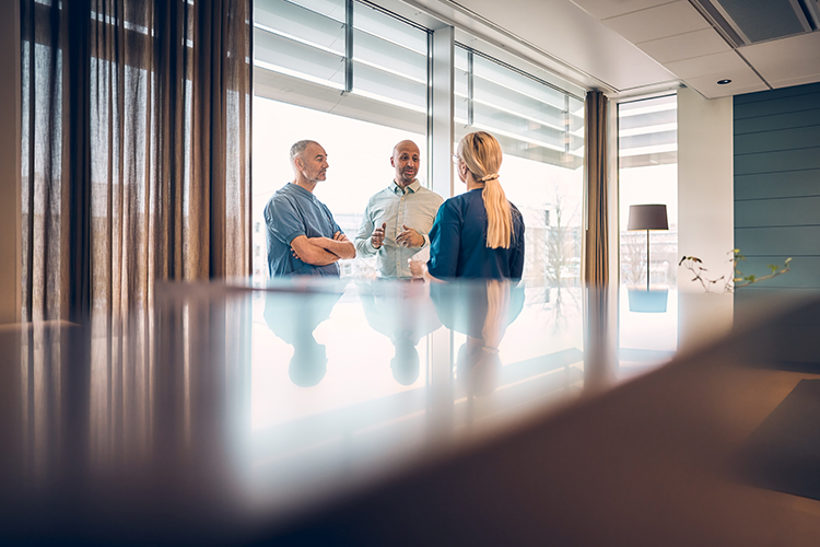 Three people meeting in a conference room