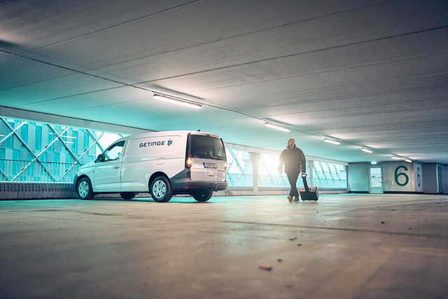 Getinge service car and technician in parking garage