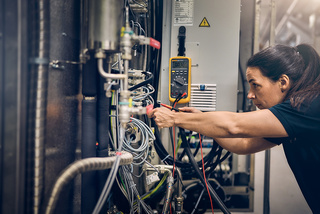 Female technician working on a machine