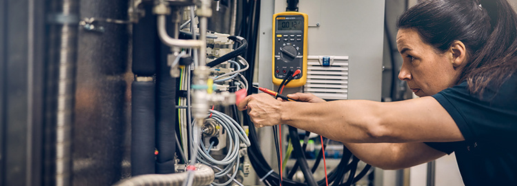Female technician working on a machine