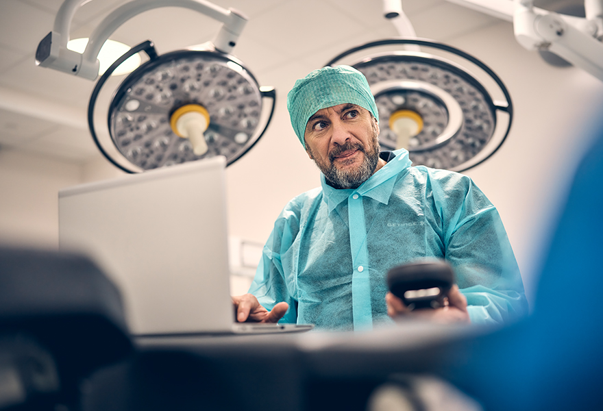Service technician in clinical environment with a laptop Service technician in clinical environment with a laptop
