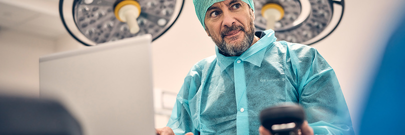 Service technician in clinical environment with a laptop
