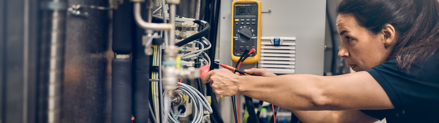 Female technician working on a machine